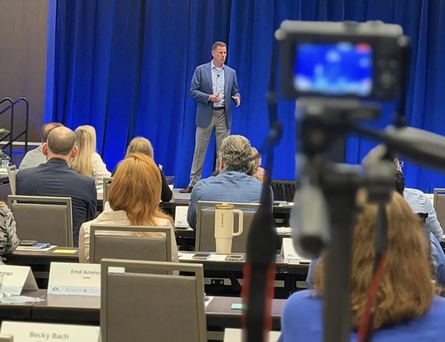 Joe Baker presenting to a conference audience