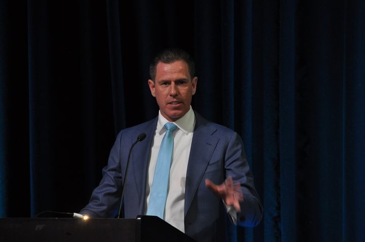 Joe Baker speaking at a podium